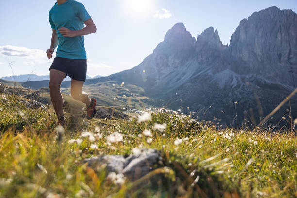 istock Young man trail running on the Dolomites mountain 1345503035