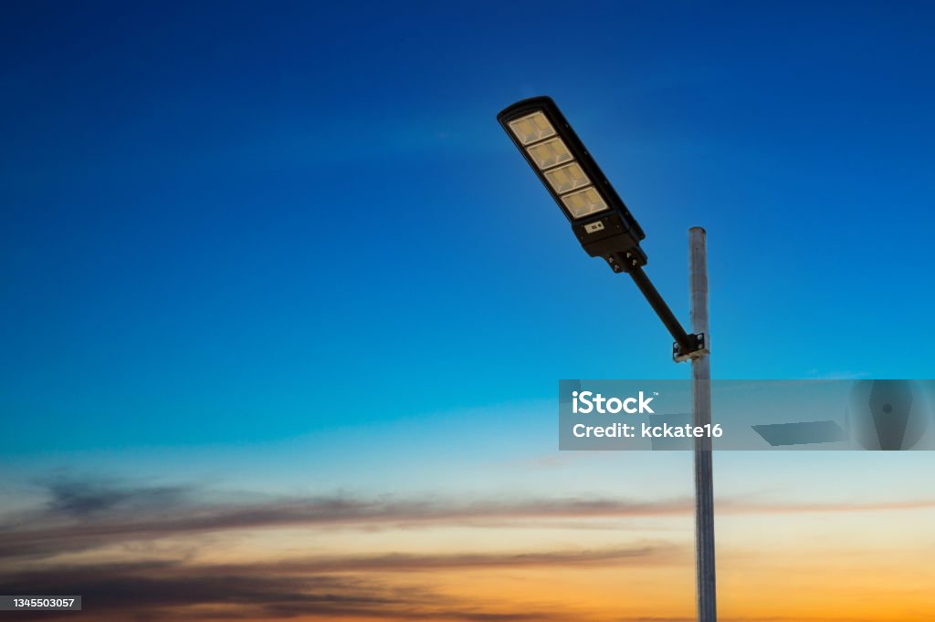 A modern street LED lighting pole. Urban electro-energy technologies. Poles on the road with LED light. Outdoor lighting strong LED lamp. Street Light Stock Photo