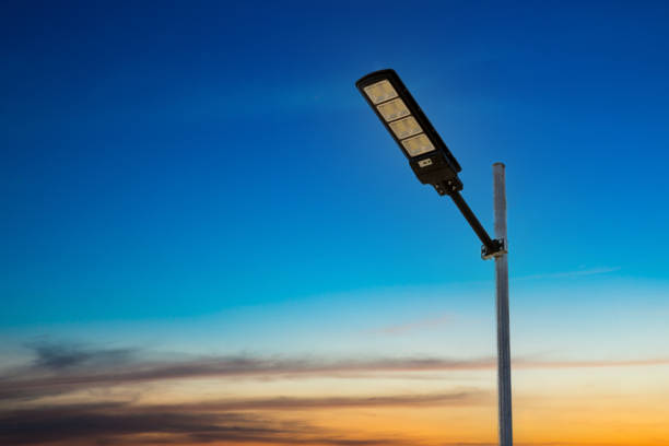 A modern street LED lighting pole. Urban electro-energy technologies. Poles on the road with LED light. Outdoor lighting strong LED lamp. stock photo
