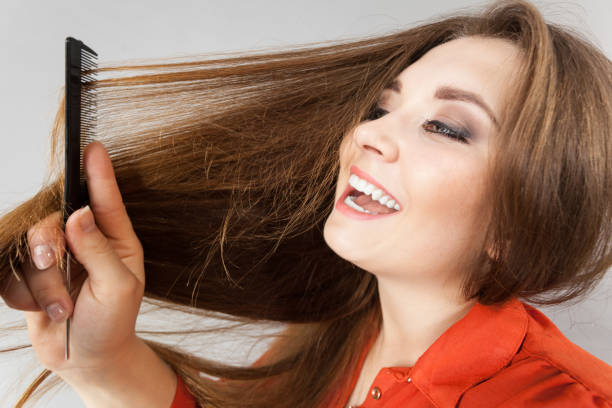 istock Woman combing her brown hair 1345503114