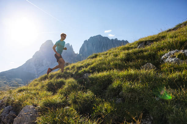 istock Young man trail running on the Dolomites mountain 1345503116