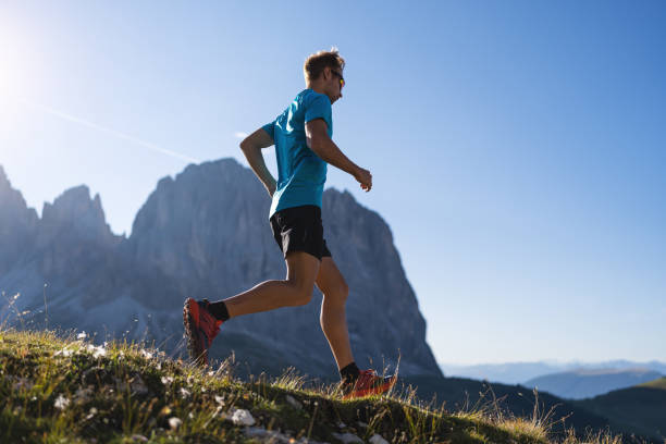 istock Young man trail running on the Dolomites mountain 1345503986