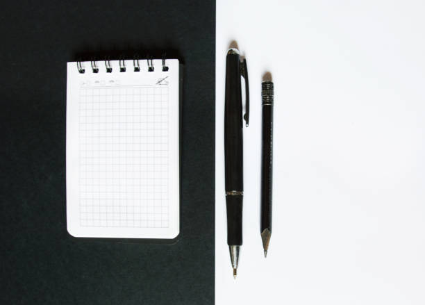 istock notebook and pen on black and white background 1345503988