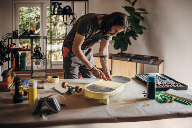 istock Man preparing skateboard for painting 1345504104