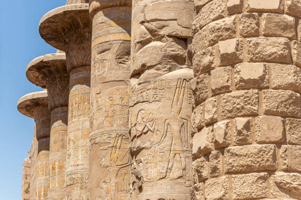 istock Massive columns after reconstruction inside beautiful Egyptian temple in Luxor with hieroglyphics 1345506391