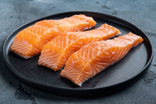 istock Raw salmon fillets, on  grey background 1345507434