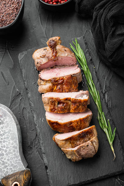 istock Roast duck fillet, on stone serving board, on black stone background 1345507547