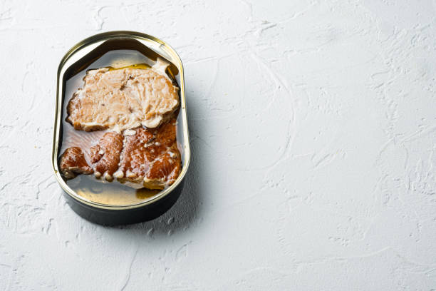 istock Wild Pink Salmon Canned smoked fish, in tin can, on white background, with copyspace  and space for text 1345508405