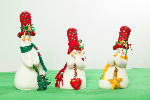 istock Christmas Decoration - Three different Snowmen dressed in Christmas time clothes 1345508966
