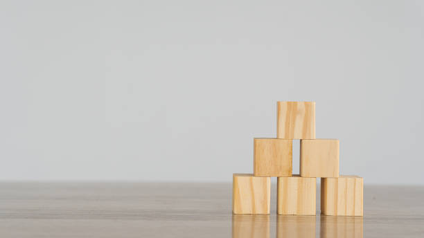 istock Creativity and innovation idea, blank wooden cube blocks arranged in a pyramid shape, white background. 1345510104