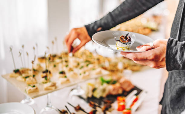 istock male hands take a snack and put it on plate. buffet in a restaurant 1345510511