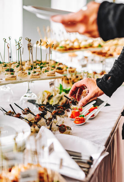 istock male hands take a snack and put it on plate. buffet in a restaurant 1345510516