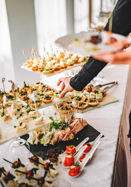 istock male hands take a snack and put it on plate. buffet in a restaurant 1345510517