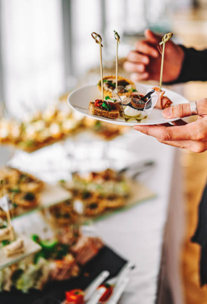 istock male hands take a snack and put it on plate. buffet in a restaurant 1345510574