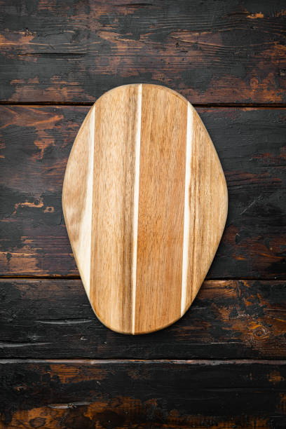 istock Scratched chopping board, on old dark  wooden table background, top view flat lay , with copy space for text or your product 1345510898