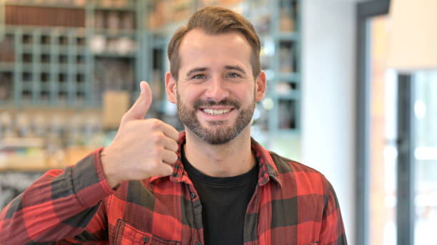 portrait of thumbs up by approving beard young man - 24241 imagens e fotografias de stock