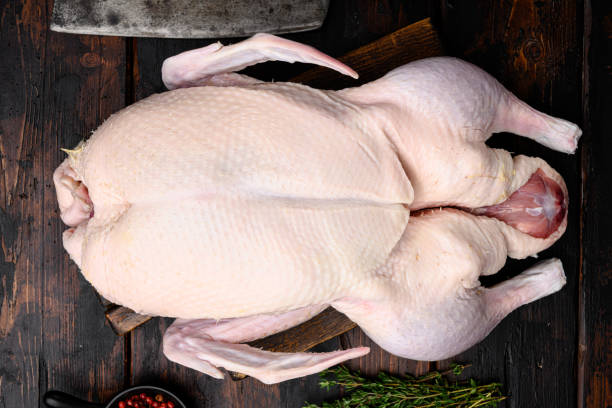 istock Fresh raw whole duck ready for cooking, on old dark  wooden table background, top view flat lay 1345512195