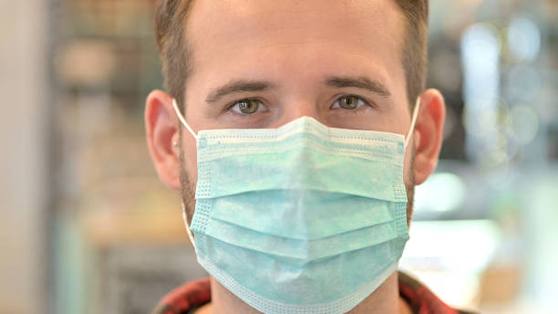 istock Close up of Man with Protective Face Mask 1345512401