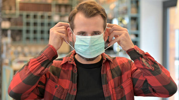 istock Portrait of Beard Young Man wearing Protective Face Mask 1345512607