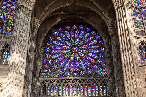 Saint denis, france, february 12, 2015 : stained glass rosace in basilica of saint-denis,  necropolis of french monarchs, anonymous artists, 12th century