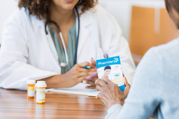 istock Doctor explains options in brochure to female patient 1345513621