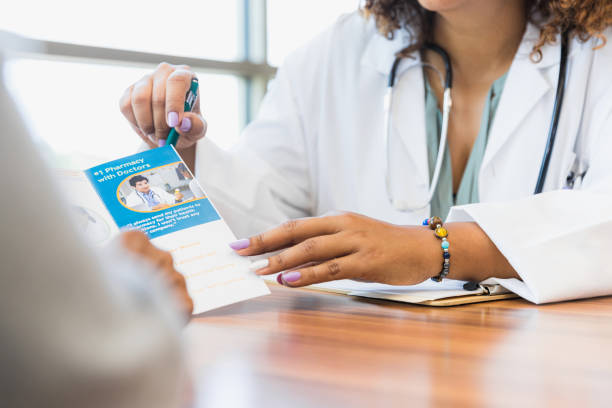 istock Close up photo doctor explaining brochure to patient 1345513646