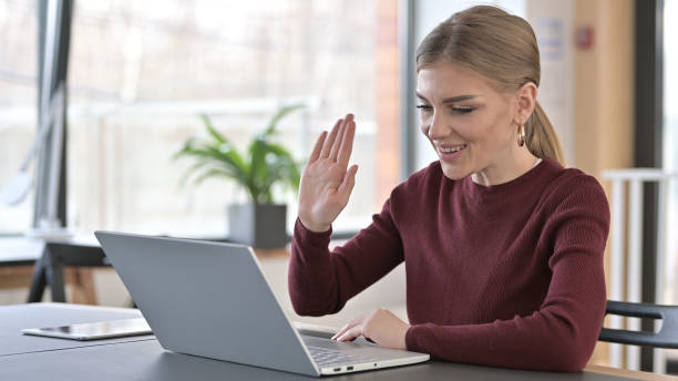 istock Video Chat on Laptop by Young Woman in Office 1345513933