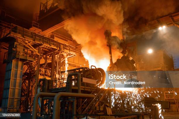 Pouring Molten Metal Into A Metallurgical Electric Arc Furnace Stock Photo - Download Image Now