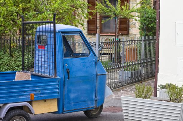 istock A traditional blue three-wheeled vehicle parked on the road (Tuscany, Italy, Europe) 1345516391