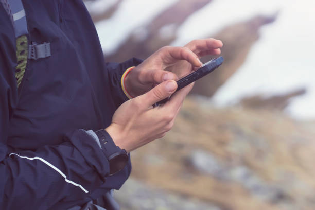 istock Man holds a smartphone in his hands and looks at a map. 1345516871