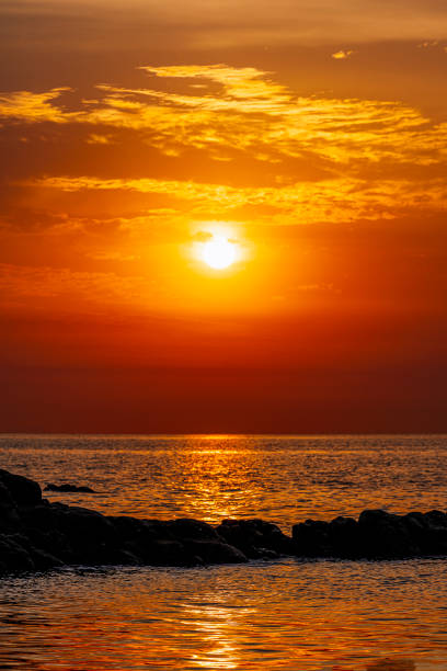 Sunlit reefs and ships at seaside in the morning