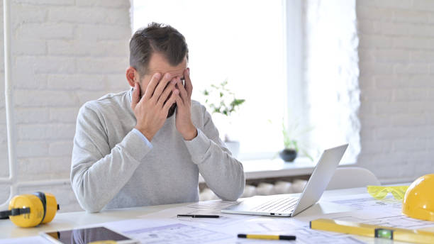 istock Frustrated Young Architect Covering Face with Hands at Work, Disappointed 1345517689