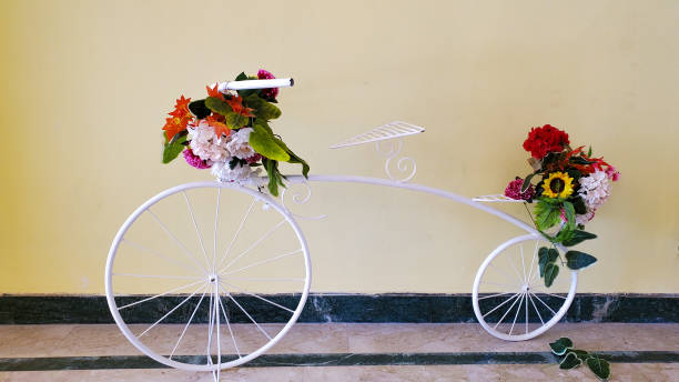 istock Decorative decoration, design solution in the form of a bicycle, a white decorative bicycle decorated with flowers 1345517921