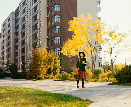 Young Caucasian woman walking in the city in autumn