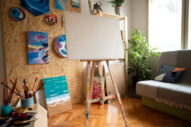 istock Blank canvas on easel in the modern and tidy home art studio 1345520166