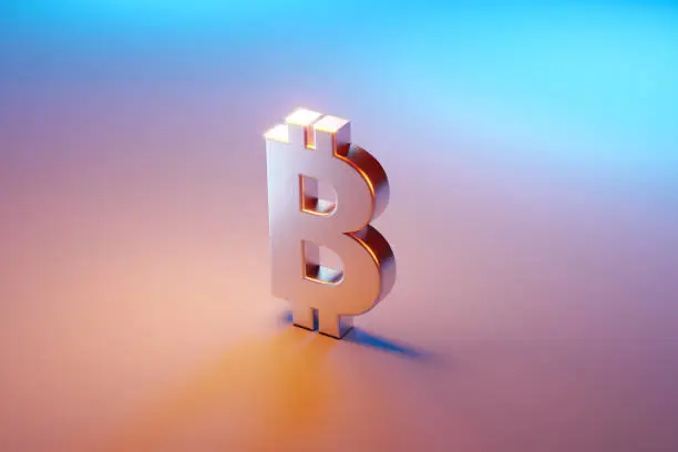 Photo of Bitcoin Symbol Sitting Over Pink And Blue Background