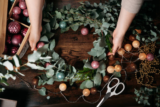 istock Top view of handmade christmas wreath on dark table 1345520626