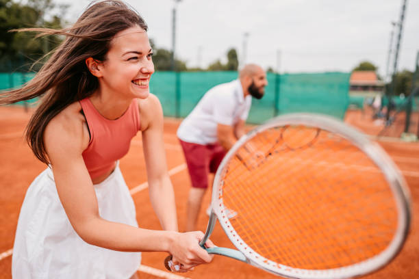 istock Tennis players playing a mix-double match 1345521477