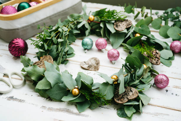 istock Green eucalyptus wreath on white wooden table 1345521595