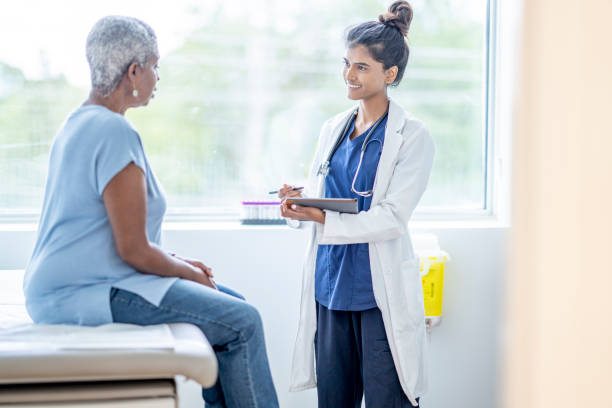 istock Doctor Recording Information from a Senior Patient 1345521707