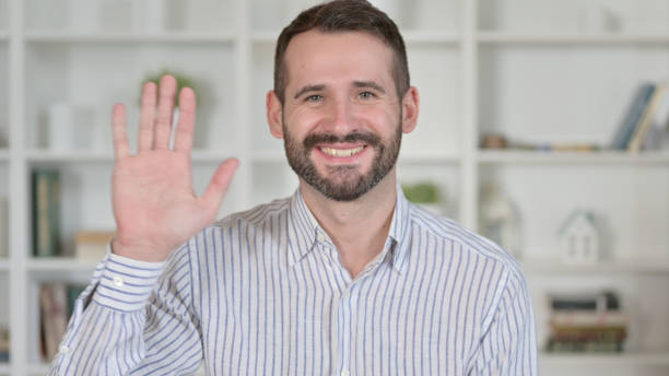 istock Portrait of Cheerful Young Man Waving, Hello 1345521765
