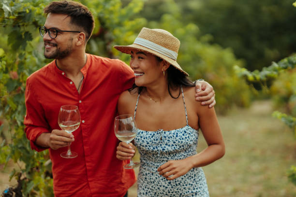 istock Couple drinking wine in vineyard 1345526453