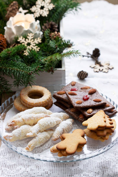 istock Assorted cookies, fir branches and a garland on a light background. 1345526461