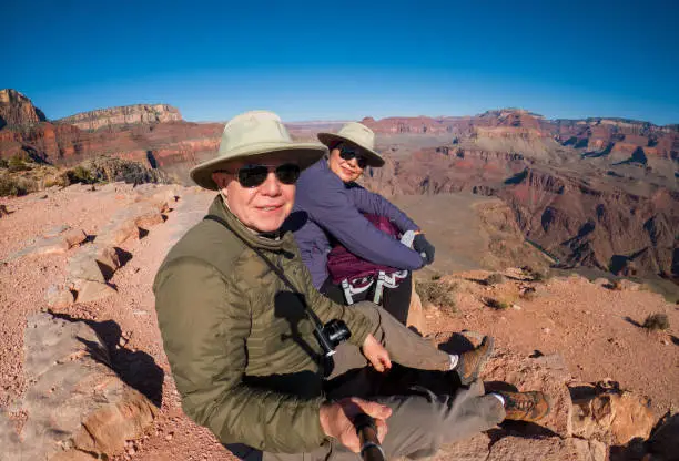 senior couple taking a selfie at the skeleton point on the Kaibab trail in Grand Canyon, Arizona