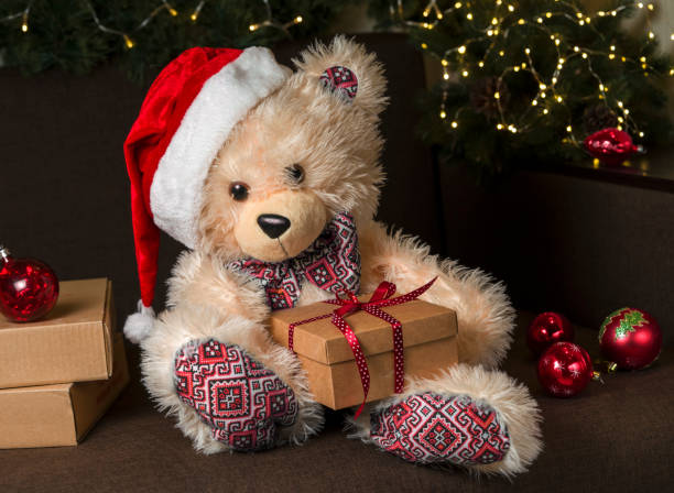 istock toy bear wearing santa hat with christmas gift 1345528189