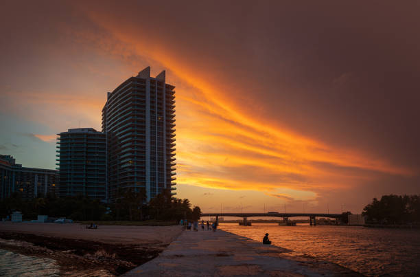 Fiery sunset Haulover inlet with Collins Avenue bridge in the back