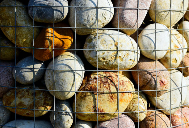 istock decorative river stone in galvanized wire mesh cage. close-up macro view. 1345530709