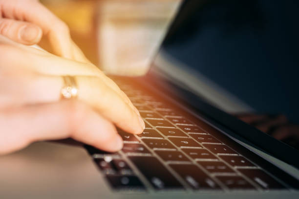 istock Woman working at laptop while sitting on bench in autumn park 1345530929