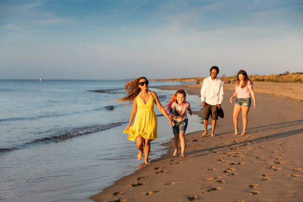 istock Family running by the beach shore 1345531051