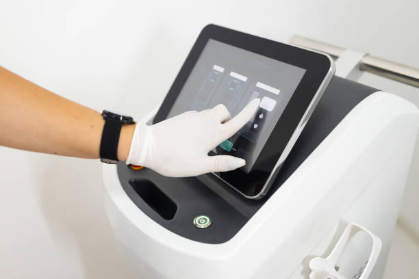 istock Doctor's hand adjusts the laser for epilation 1345531994